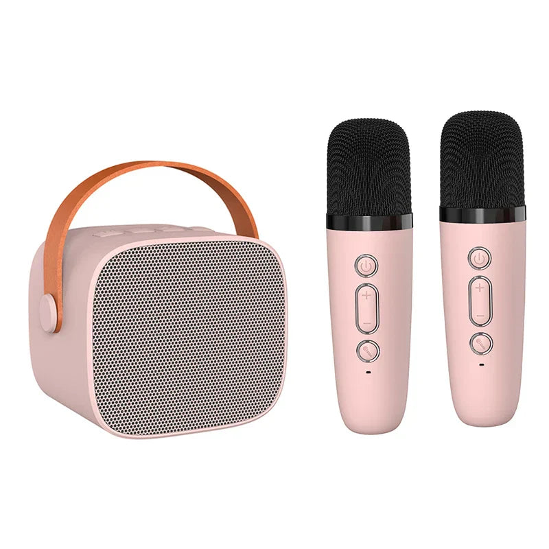 Pink mini karaoke machine for kids portable speaker with tan leather handle and two matching wireless microphones for party gifts