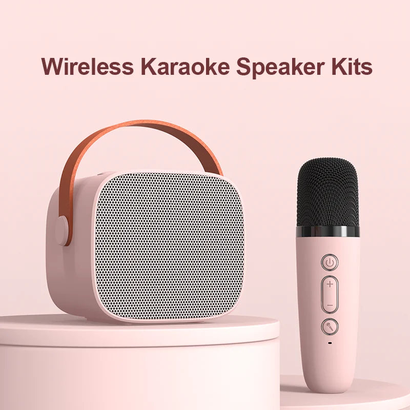 Pink mini karaoke machine for kids portable speaker with brown leather handle and matching wireless microphone for parties