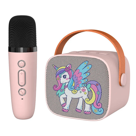 Pink unicorn-themed kids portable speaker with tan leather handle and wireless microphone for karaoke machine use