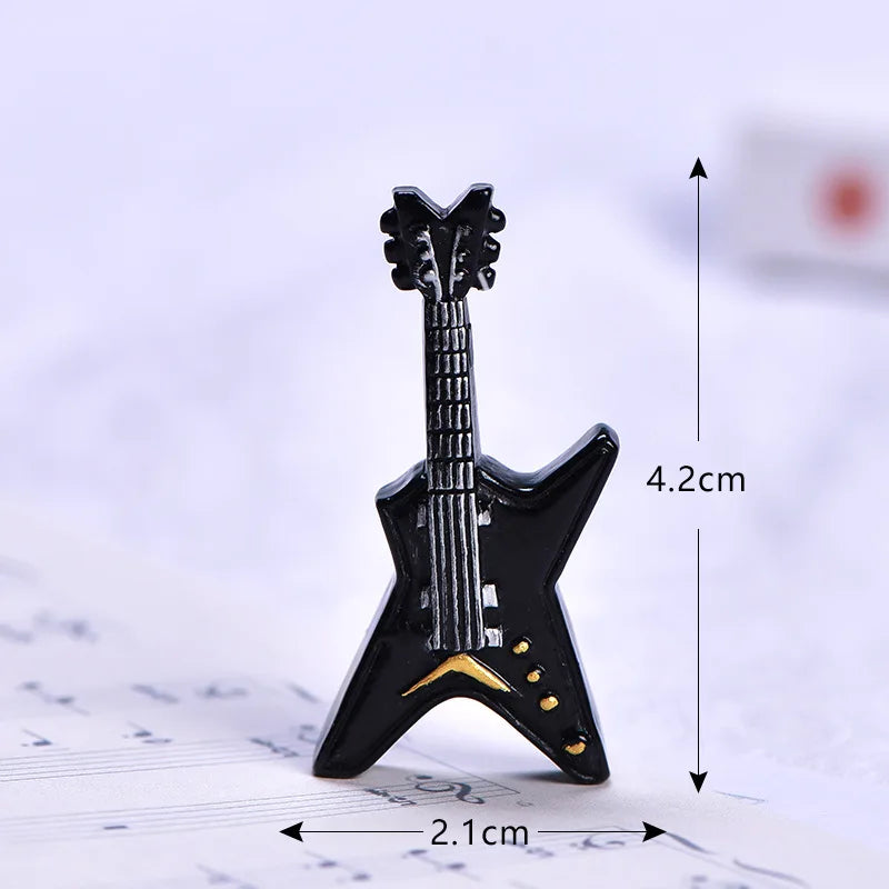 Black star-shaped electric guitar miniature musical instrument figurine with gold accents for house decor accessory