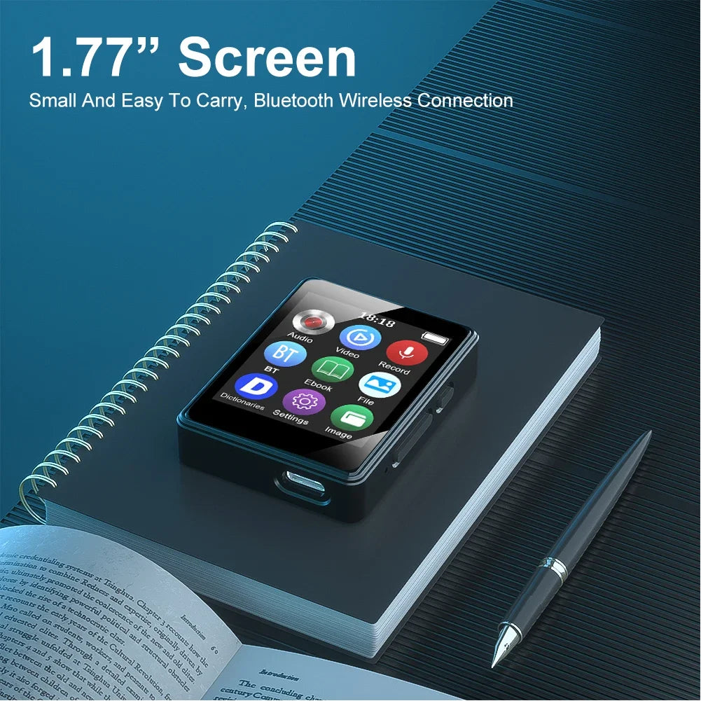 Black portable music player with 1.77-inch screen and usb-c port mp4 player bluetooth resting on spiral notebook