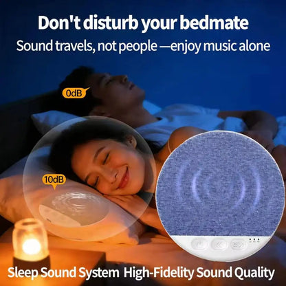 White circular mini sleeping bluetooth speaker with textured blue fabric top and control buttons on base noise soundbar wireless