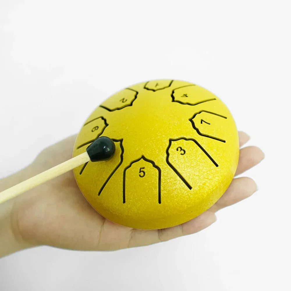 Bright yellow steel tongue drum 4 inch with 8 notes and black engraved numbers with matching black-tipped mallet