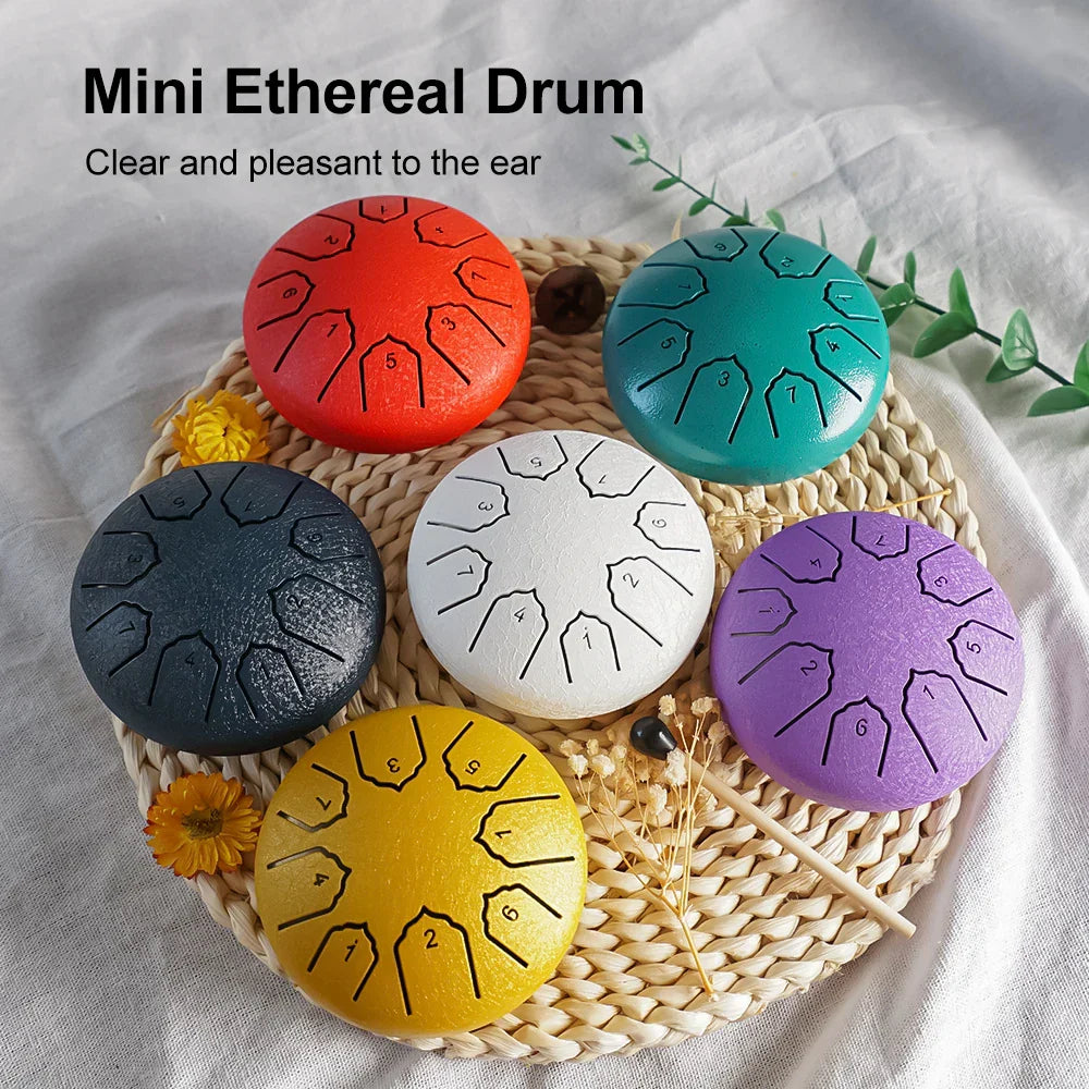 A set of six colorful mini steel tongue drums with engraved number notes on smooth metallic surfaces for outdoor use
