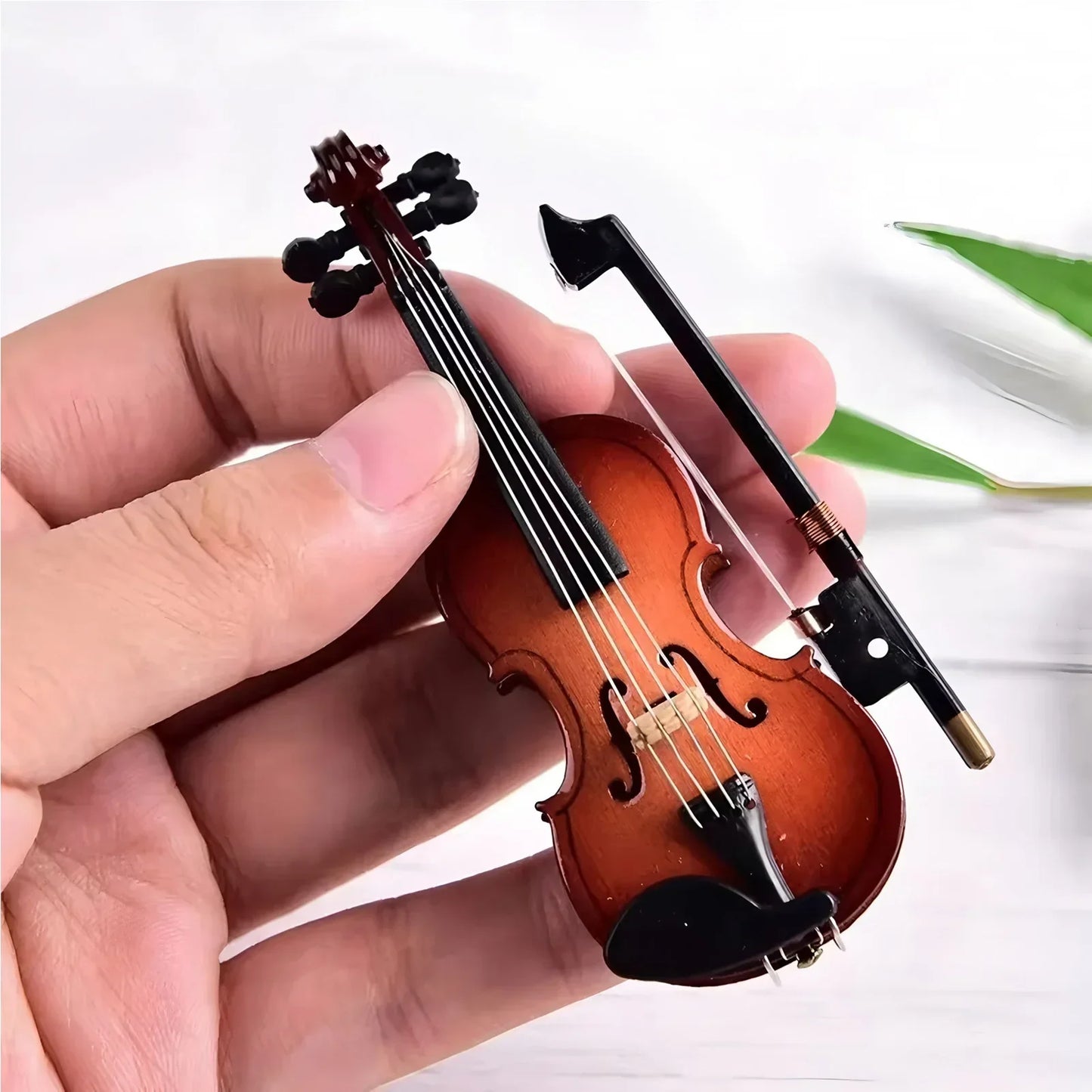 Mini violin model with warm amber-brown finish black accents and matching bow on stand basswood wooden for musicians music lovers