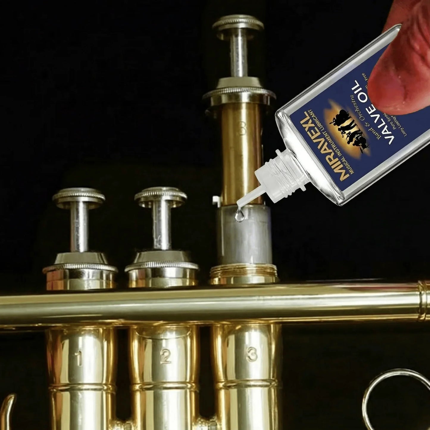 A clear plastic miravexl 30ml musical valve oil grease bottle is used to lubricate saxophone brass horn valves