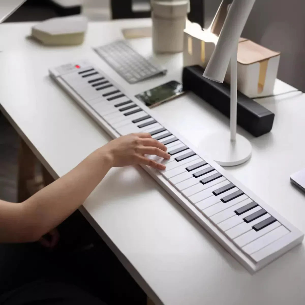 White 61-key portable folding electronic piano keyboard with black keys tones and 100 rhythms built-in and LED display