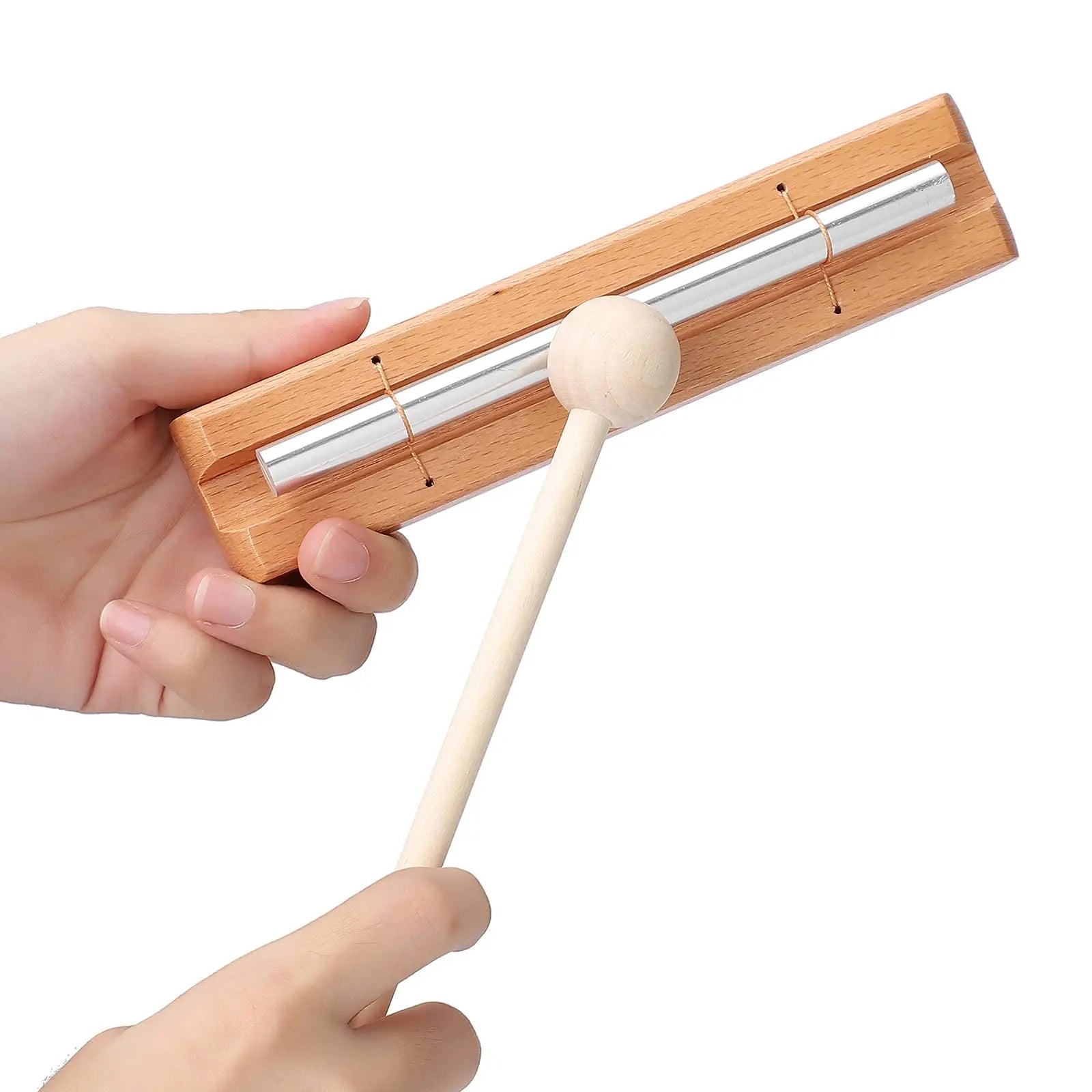 A wooden-handled mallet poised to strike a silver tuning fork in a wood case for miwayer energy chimes music instrument