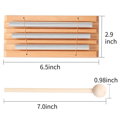 A wooden-framed miwayer energy chime with three silver metal tubes and a wooden mallet for bell meditation chimes and teacher use