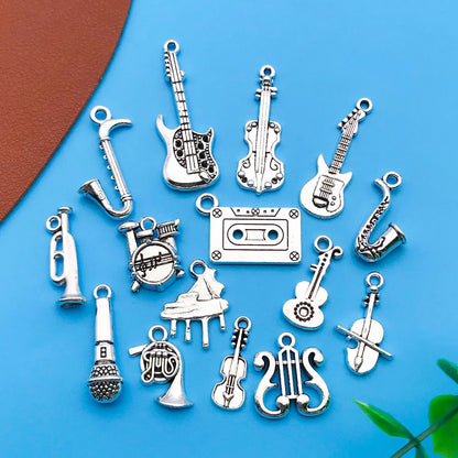Silver-toned mix 15pcs antique musical instrument charms featuring guitar piano violin designs for jewelry making