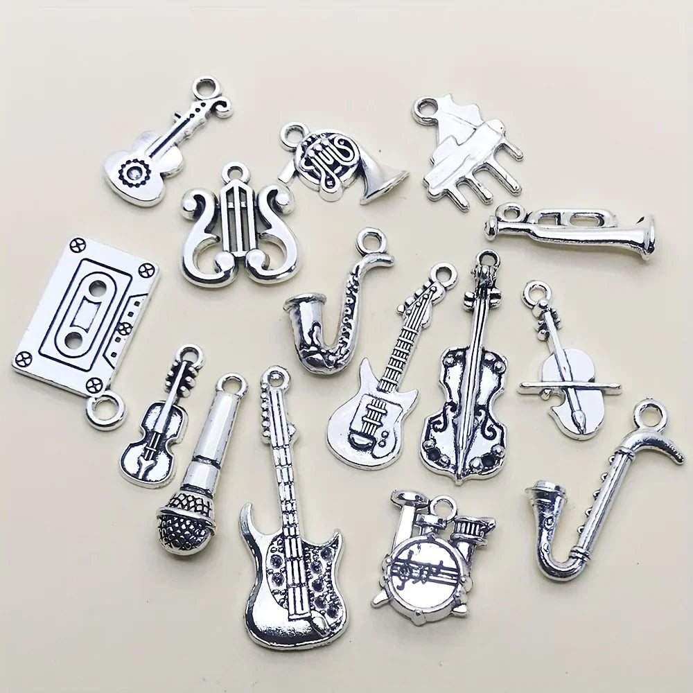 Silver-toned antique silvery musical instrument charms featuring detailed guitars saxophones violins and cassette tape for jewelry making guitar piano violin music crafts
