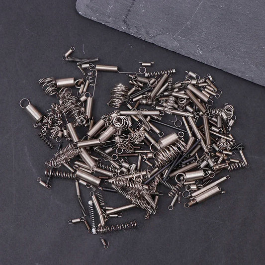 A collection of assorted metallic mixed loading springs for music player audio tape drive movement accessories