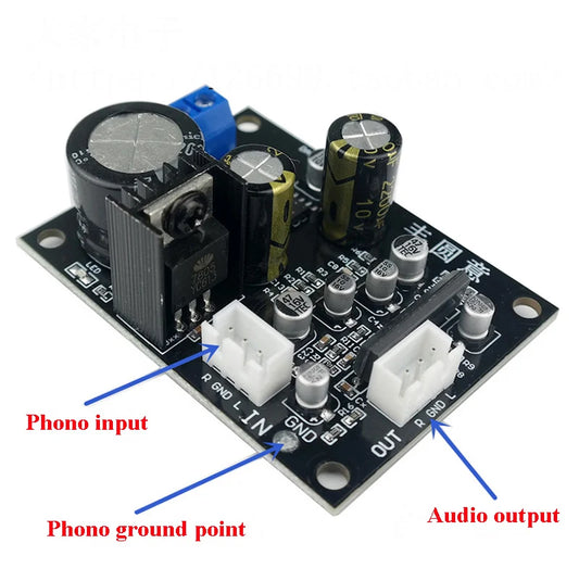 Black printed circuit board with capacitors and connectors for phono input output in turntable phonograph preamplifier