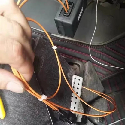 Orange fiber optic cables secured with white ties on the back side of mmi 2g bluetooth music adapter adapter foraudi a6l