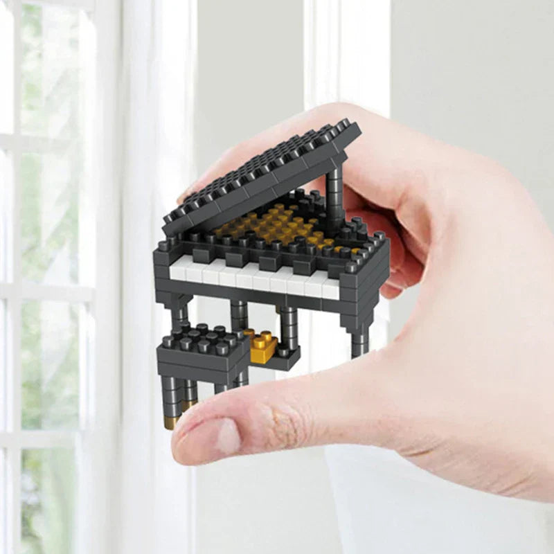 A miniature black and gold piano musical instrument building blocks made of ABS plastic for piano guitar DIY assembly