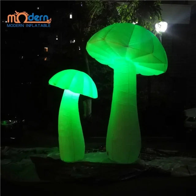 Two glowing green giant inflatable mushrooms illuminated with rgb led lights made of oxford cloth advertising material