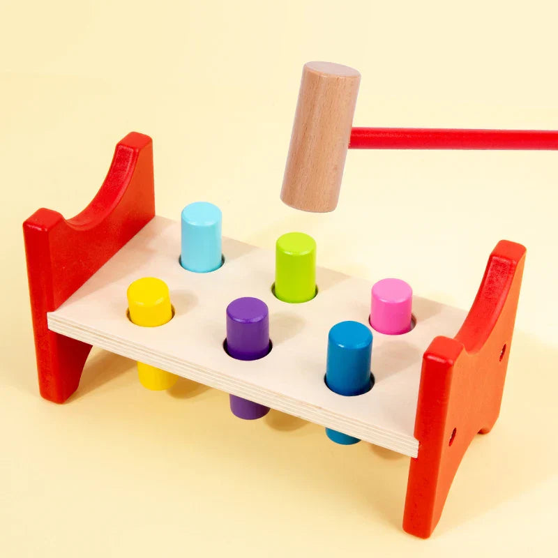 Montessori-style red wooden hammer toy with colorful pegs for early learning percussion and educational musical instrument play