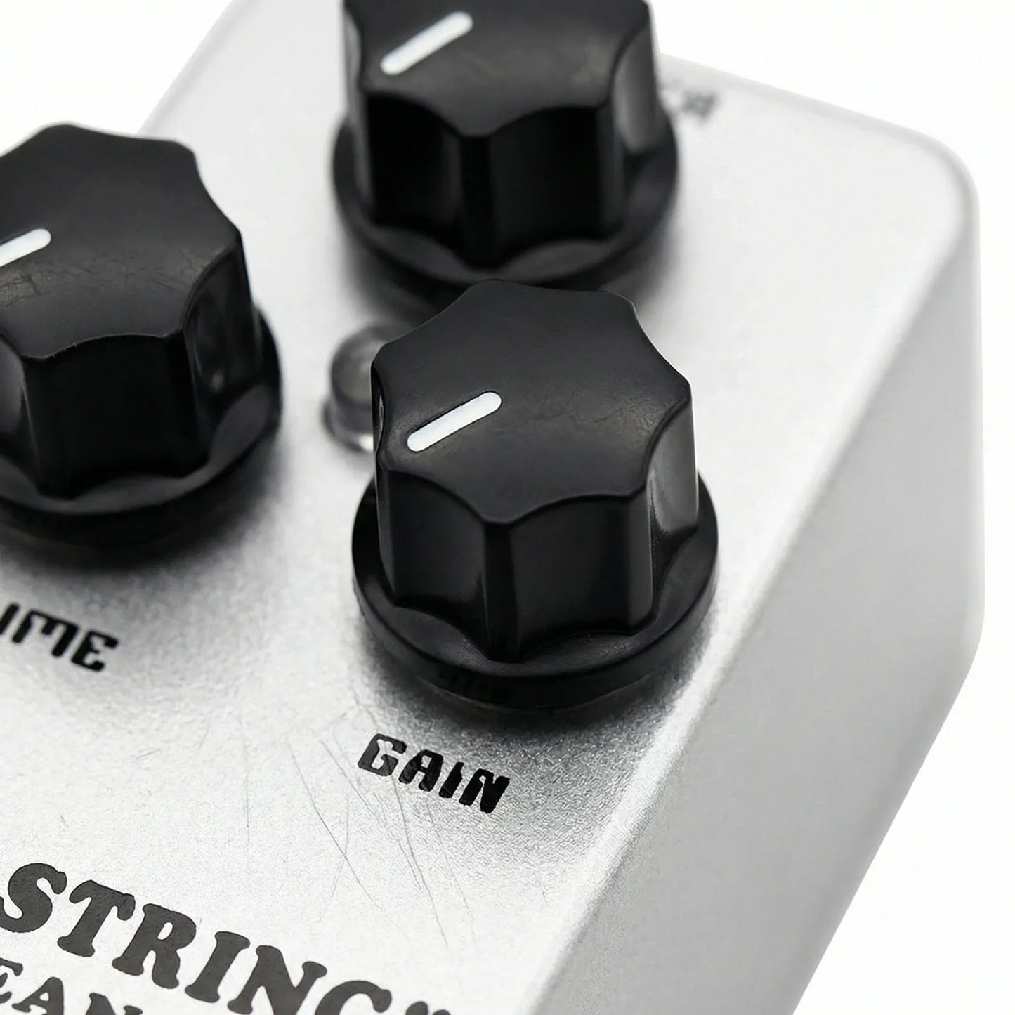 Silver metal mosky mini string clean drive overdrive guitar pedal with three black hexagonal knobs and white indicators