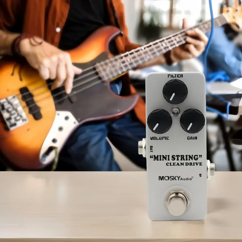 A sleek silver mosky mini string clean drive overdrive guitar pedal with three black knobs for filter volume and gain