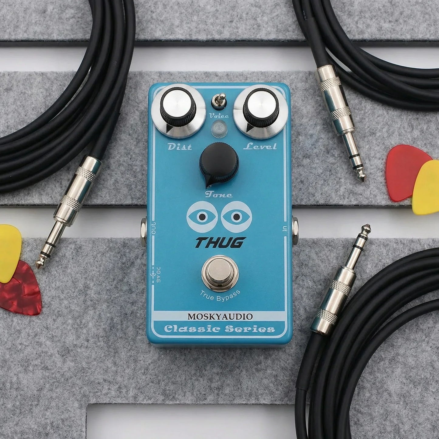 Light blue mosky thug distortion guitar pedal with adjustable dist and level knobs for high gain tone control