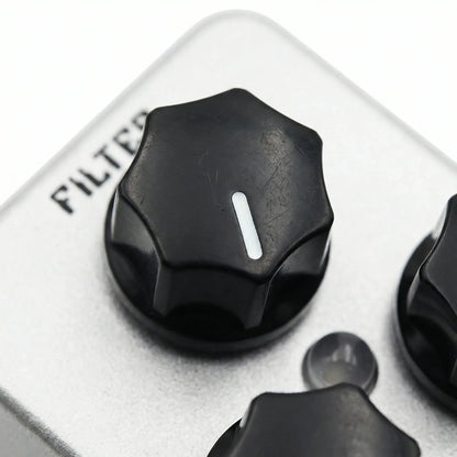 Black hexagonal knob with white stripe on silver panel of moskyaudio mini string clean drive overdrive guitar pedal