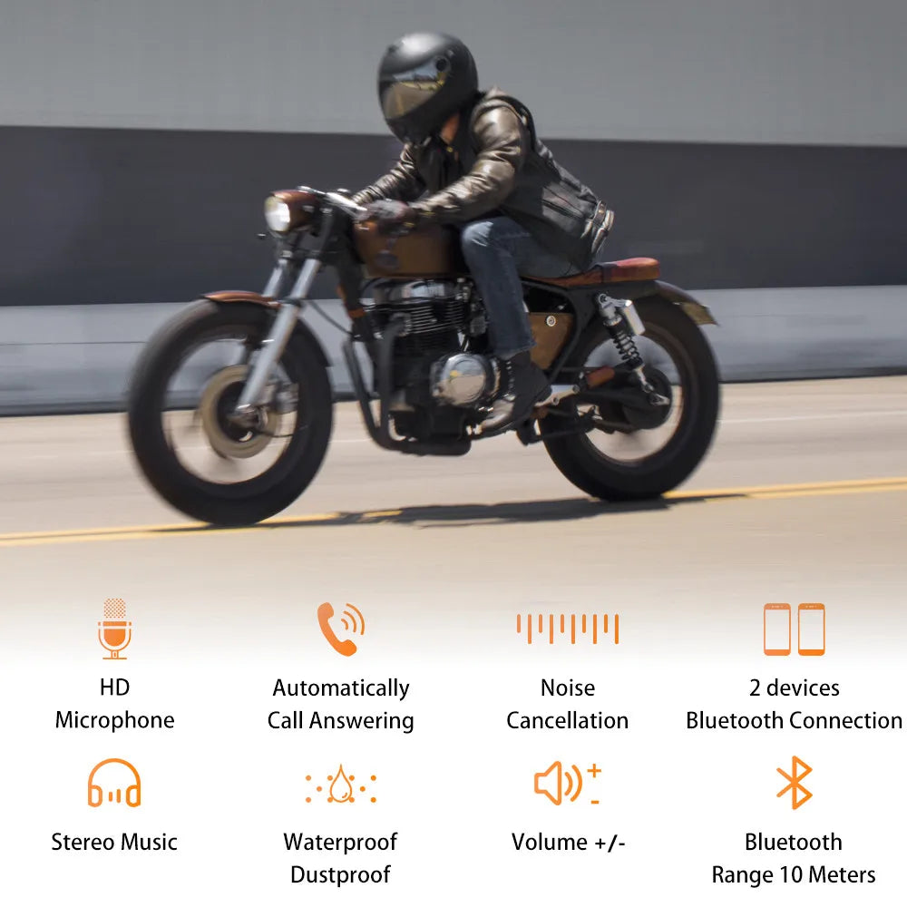 Black motorcycle helmet headset with reflective visor and wireless handsfree mic worn by rider on brown and black motorbike