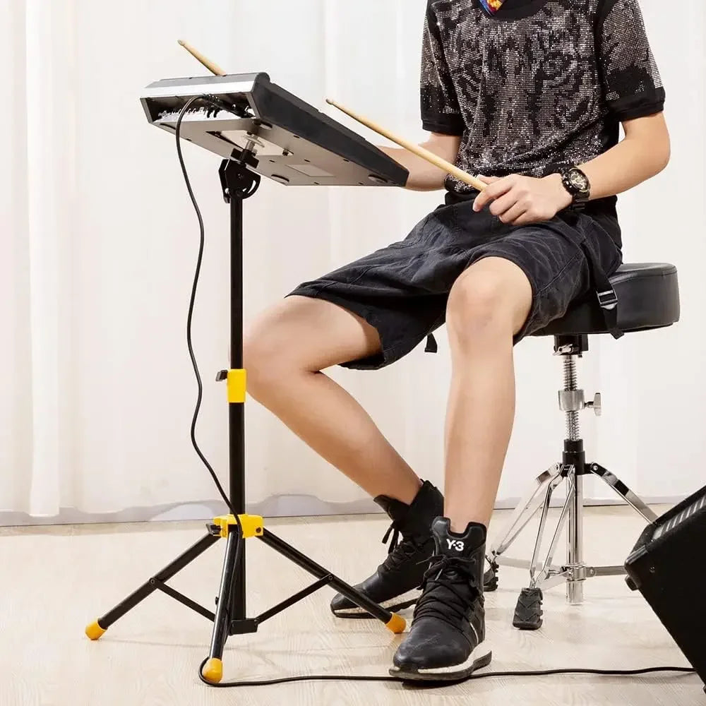 Black electronic drum kit with yellow accents on mounting stand for percussion instruments electronic sample pad roland use