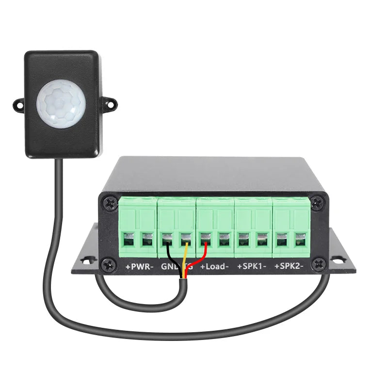 Black plastic touch-free sensor with white lens connected to a control box with green terminals for play multiple audio use