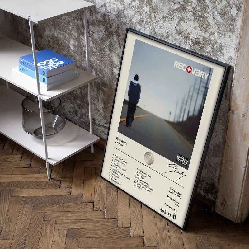 Black-framed poster of eminem recovery album with minimalist design tracklist and artist signature for wall decor gift
