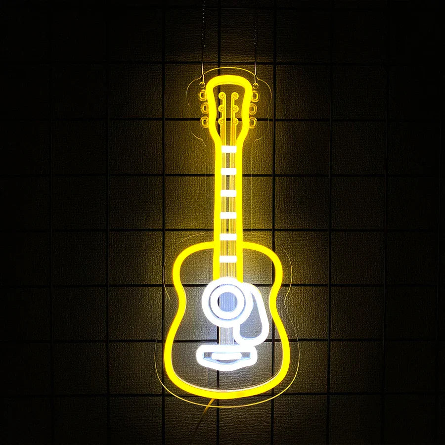 A glowing yellow neon sign shaped like a guitar with white accents for room and music studio decor