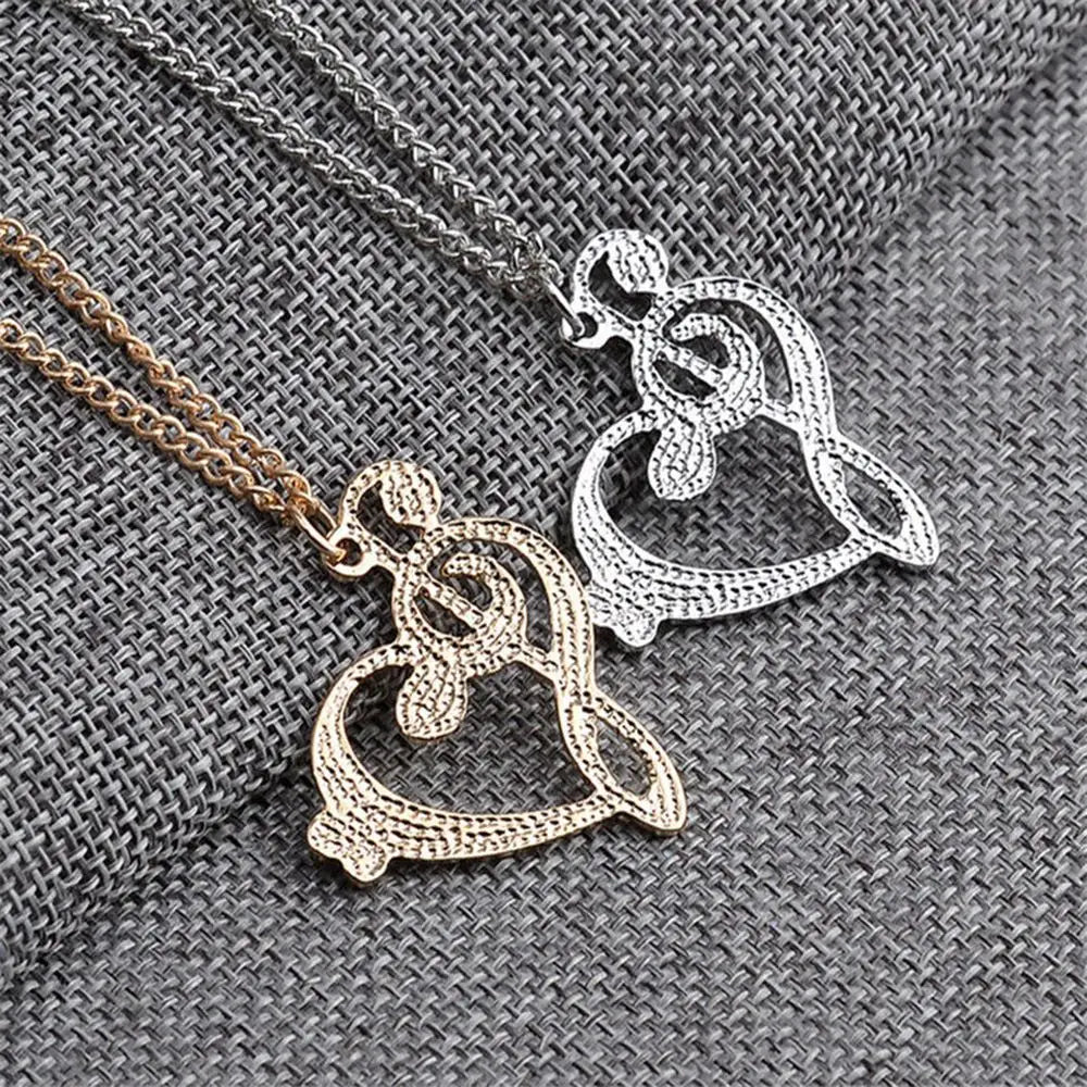 Gold and silver piano key pendant necklaces featuring intricate textured designs in stainless steel music note heart jewelry
