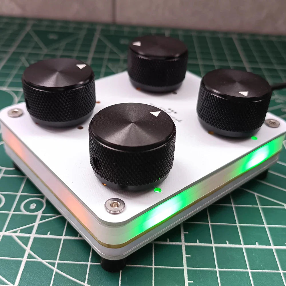 White rectangular 4-knob midi controller with black knurled knobs glowing green led strip and usb-c interface
