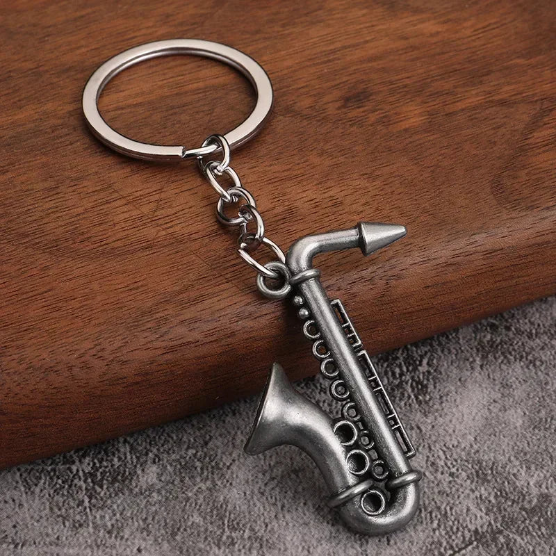 Silver-toned metal saxophone keychain with detailed keys and chain attachment for women keyrings mini or small gift men