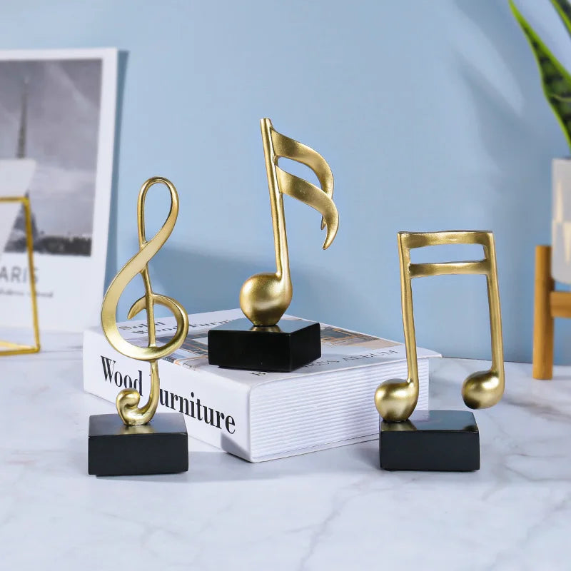Three golden musical note statue crafts ornaments with black bases made of music symbols resin for room decoration