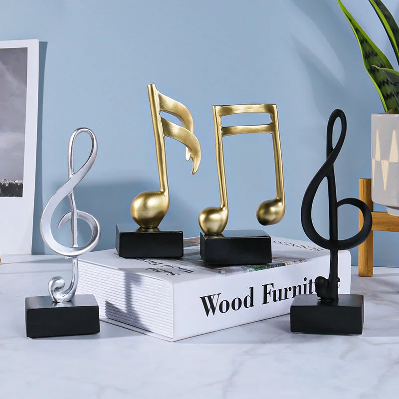 Three metallic music symbols resin crafts ornaments piano in gold and silver finishes on black bases for decoration