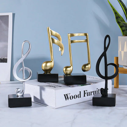 Three metallic music symbols resin crafts ornaments piano in gold and silver finishes on black bases for decoration