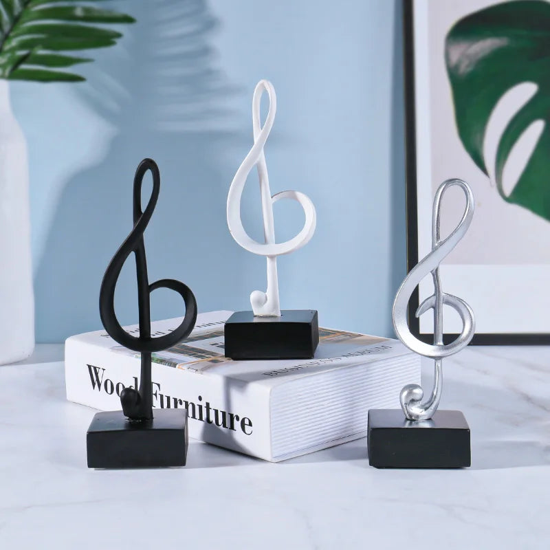Three sleek minimalist treble clef music symbols resin crafts ornaments piano statues in black white and silver on square bases