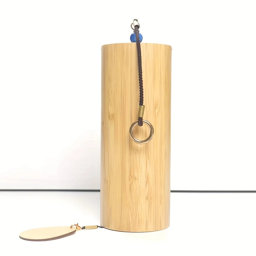 Light-colored bamboo singing bowl with braided cord and metal ring attachment for refined meditation bells creating melodies