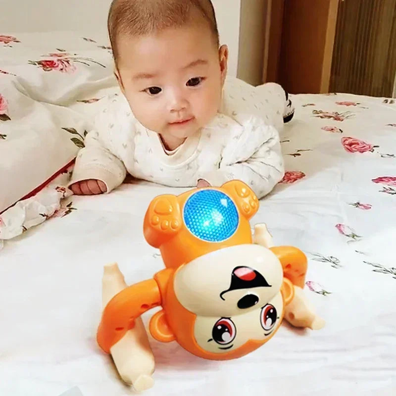 Orange and white plastic musical crawling monkey toy with a blue light for interactive light-up dancing and tummy time gifts