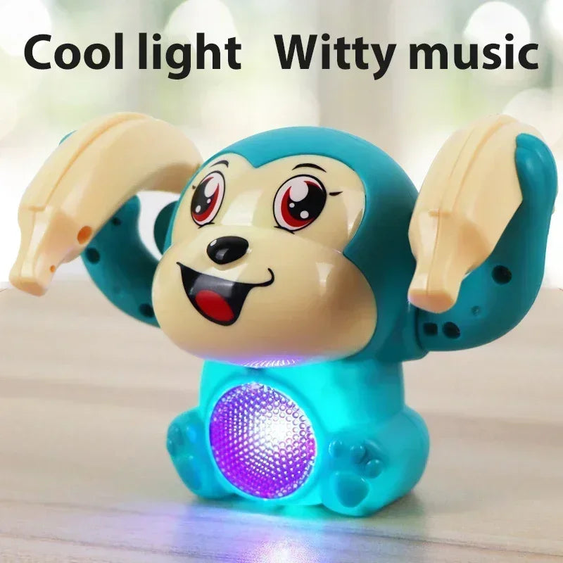 Turquoise and beige plastic musical crawling monkey toy with glowing purple belly lights for interactive light-up dancing and tummy time gifts