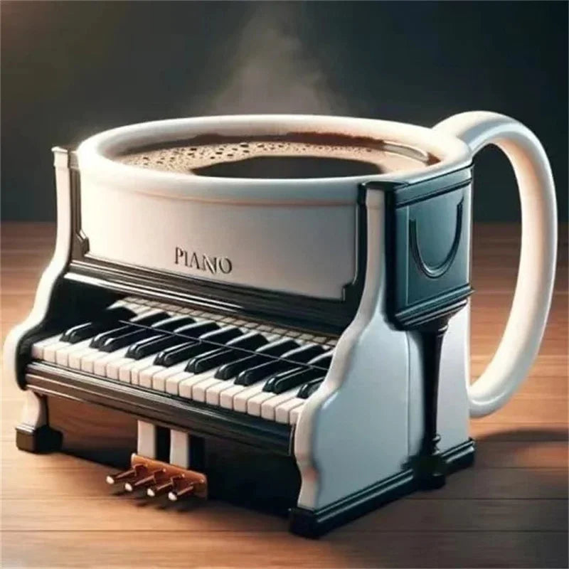 A white and black piano-shaped ceramic coffee mug with steam ideal as a musicians birthday gift or office desk table decor