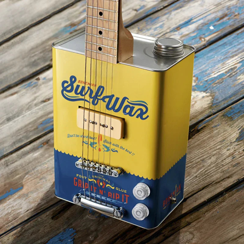 A yellow and blue musical instrument guitar made from a repurposed metal can with wooden fretboard and strings