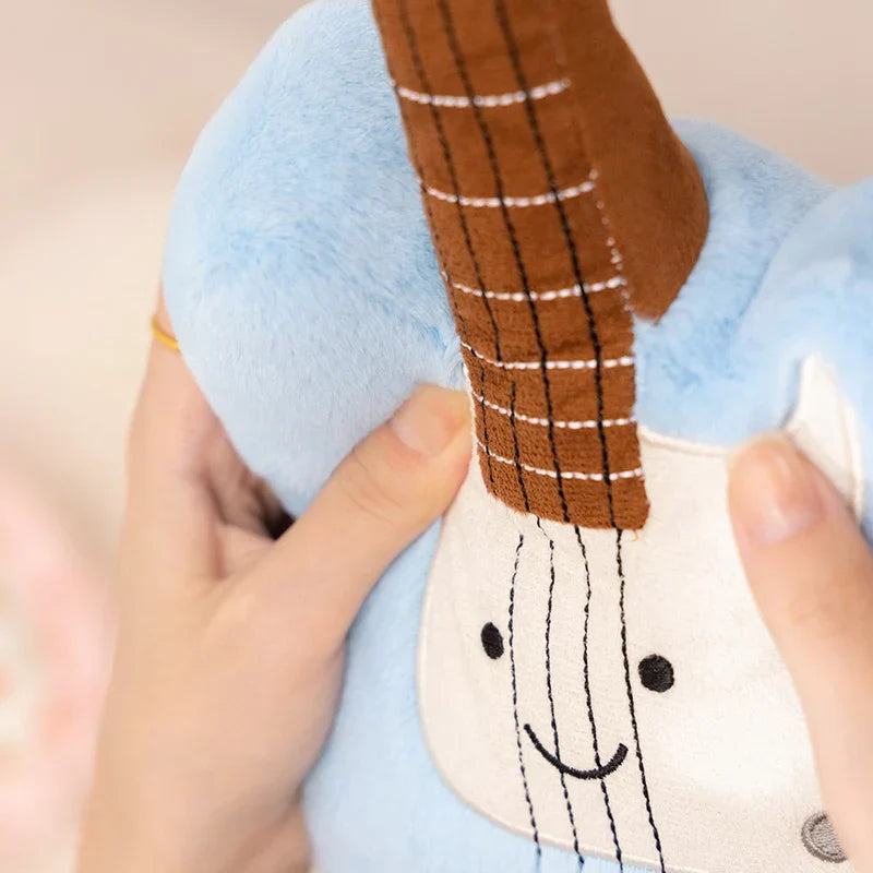 Blue plush guitar stuffed toy with brown embroidered neck and white face from musical instrument series plush toy collection
