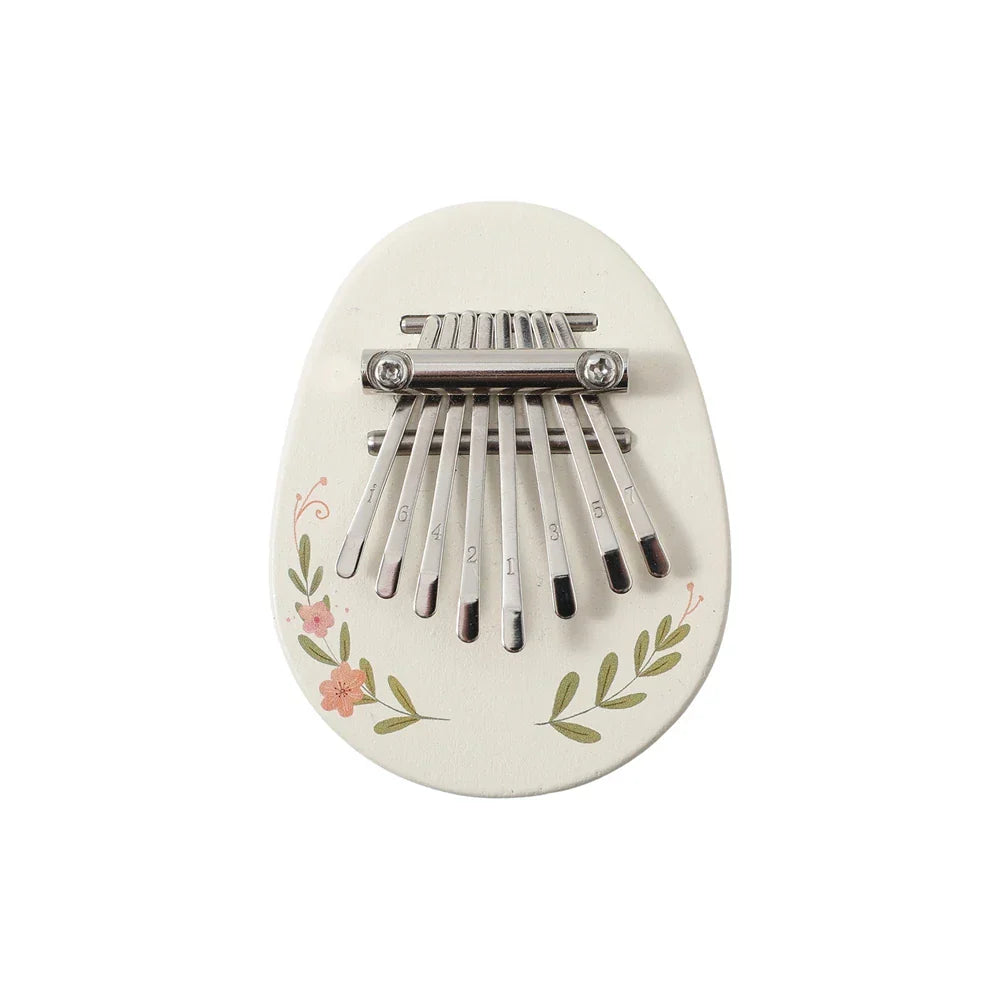 A white ceramic kalimba with floral design and silver tines for early educational wooden musical instruments montessori toys