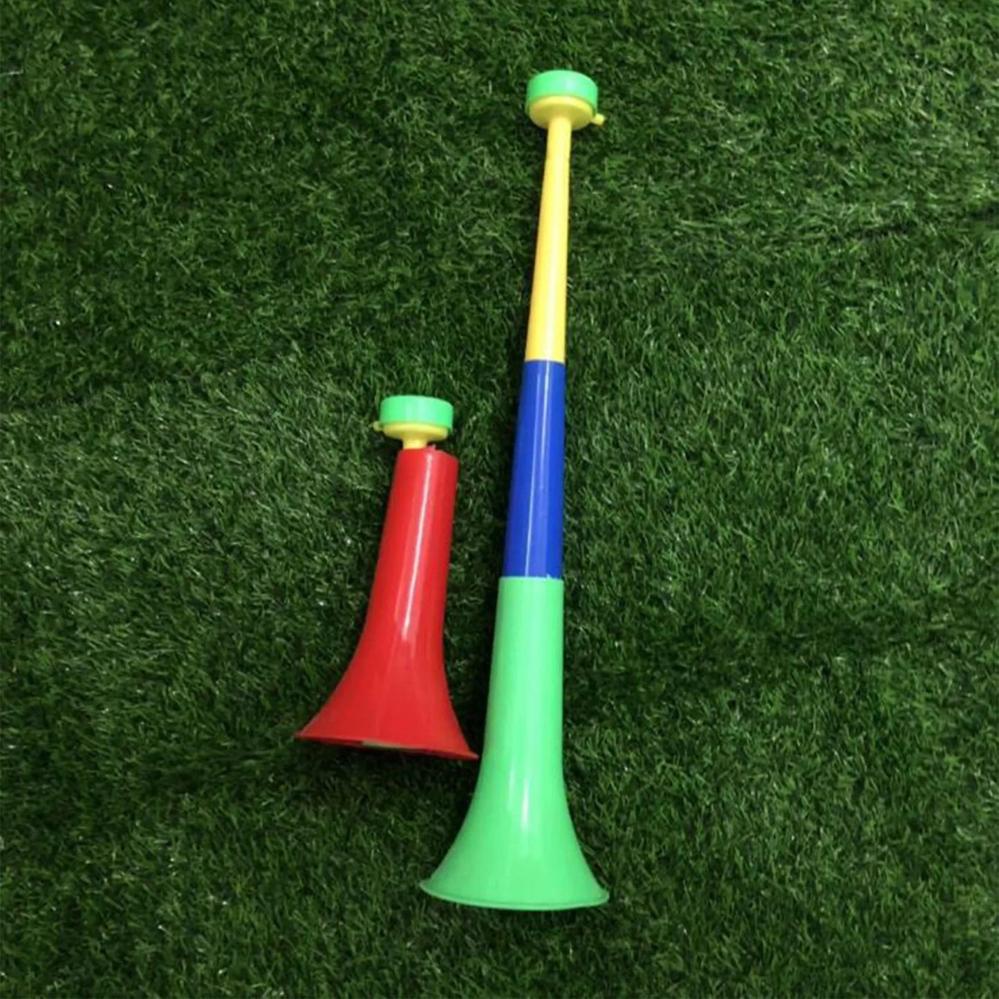Two colorful plastic cheer fan horns in red and yellow-blue-green gradient for removable football stadium use