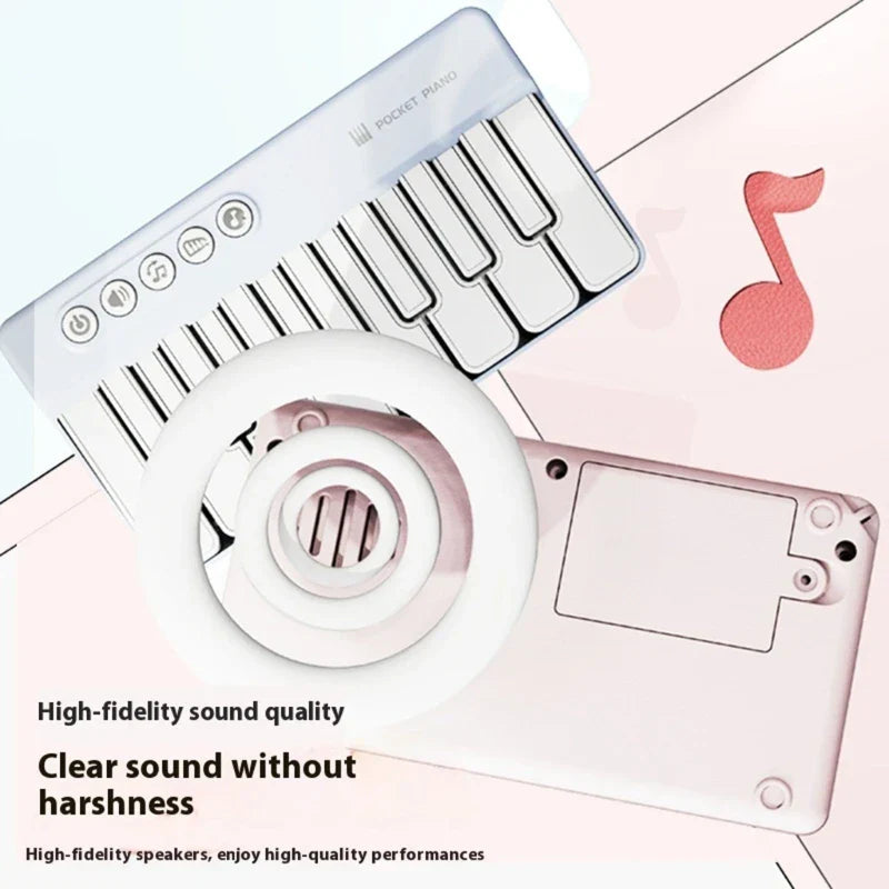 White plastic musical learning toy piano with silver accents and circular speaker grille for building basic music skills