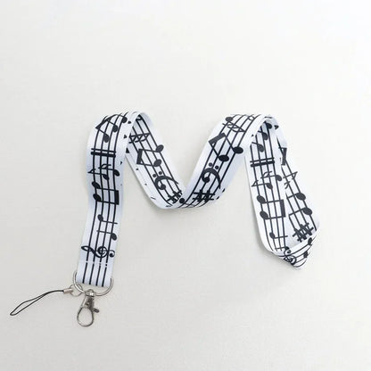 White musical notes lanyard with black notation, silver metal clasp, small loop for strap id card or rope cell phone use