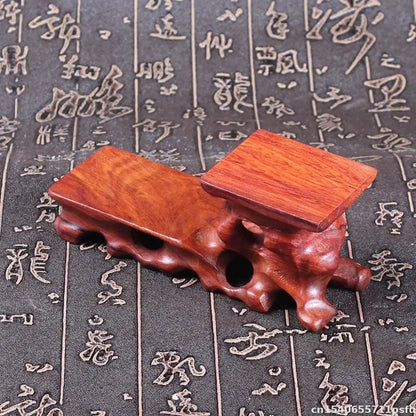 A polished reddish-brown natural solid wood decorative shelf with carved base for buddha vase flower display