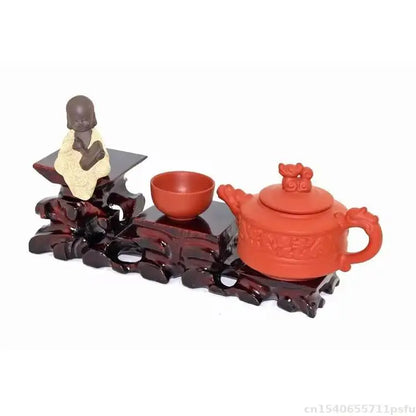 Red clay teapot and cup on a natural solid wood decorative shelf for buddha vase flower pot bonsai display