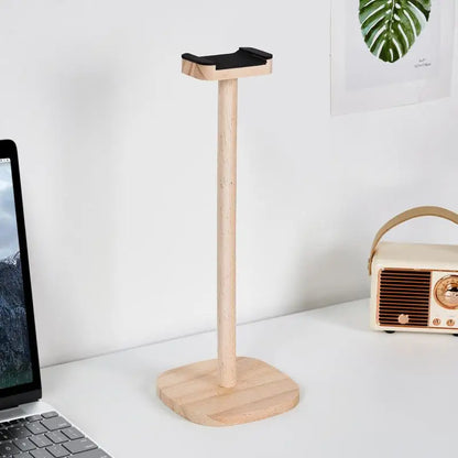 Natural wood headphone stand with black padded top and stable base for gaming over-ear headphones use